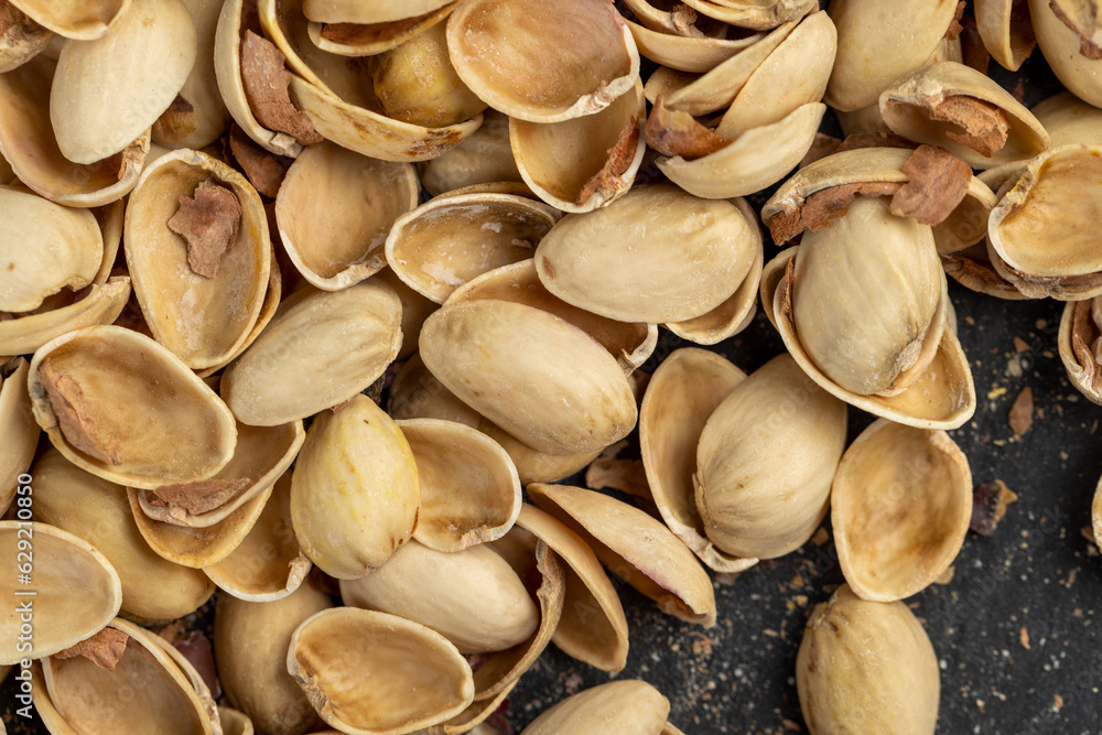 empty shells from salted pistachio nuts on the table empty shells from salted pistachio nuts on the table