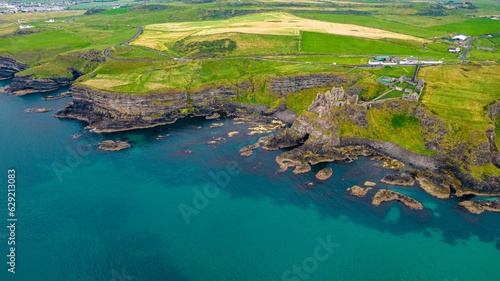 Fototapeta Naklejka Na Ścianę i Meble -  Aerial view of the historic Dunluce Castle located in the Antrim region of Northern Ireland