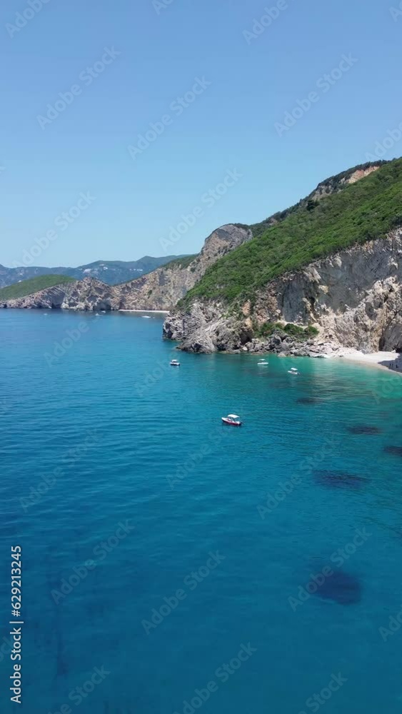 Vertical drone view over an azure seacoast with forested cliffs in Corfu, Greece Vertical drone view over an azure seacoast with forested cliffs in Corfu, Greece
