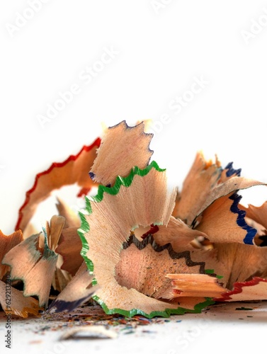 Pile of colorful wooden pencil shavings on a white background