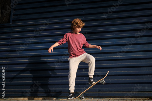 Boy doing stunt on skateboard on street
