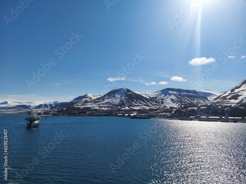 Serene Winter Landscape: Majestic Mountains, Pristine Snow, and Tranquil Sea a view from svalbard and jan mayen norway photo