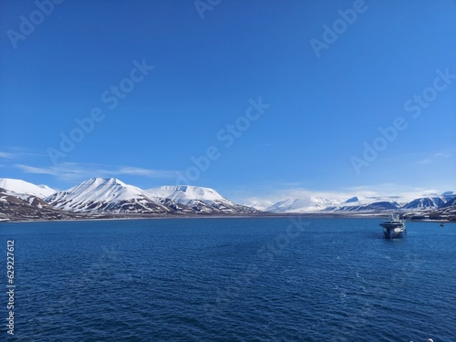 Serene Winter Landscape: Majestic Mountains, Pristine Snow, and Tranquil Sea a view from svalbard and jan mayen norway photo