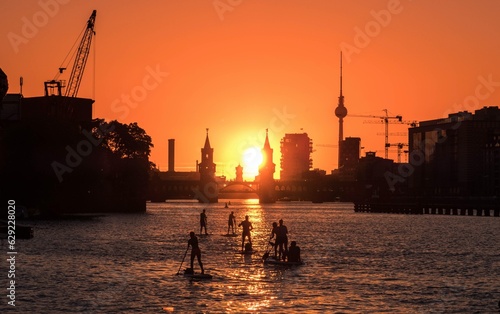 Photography People enjoying summer in Berlin on river with sunset sky, Oberbaum Bridge, Tv T