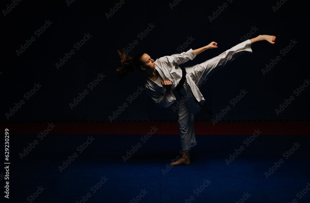 Karate girl doing Mawashi Geri