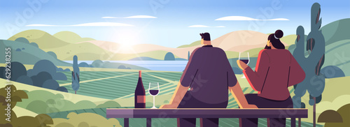 couple drinking wine enjoying landscape view of with clear river mountain ridge green meadow shores nature tourism travel adventure