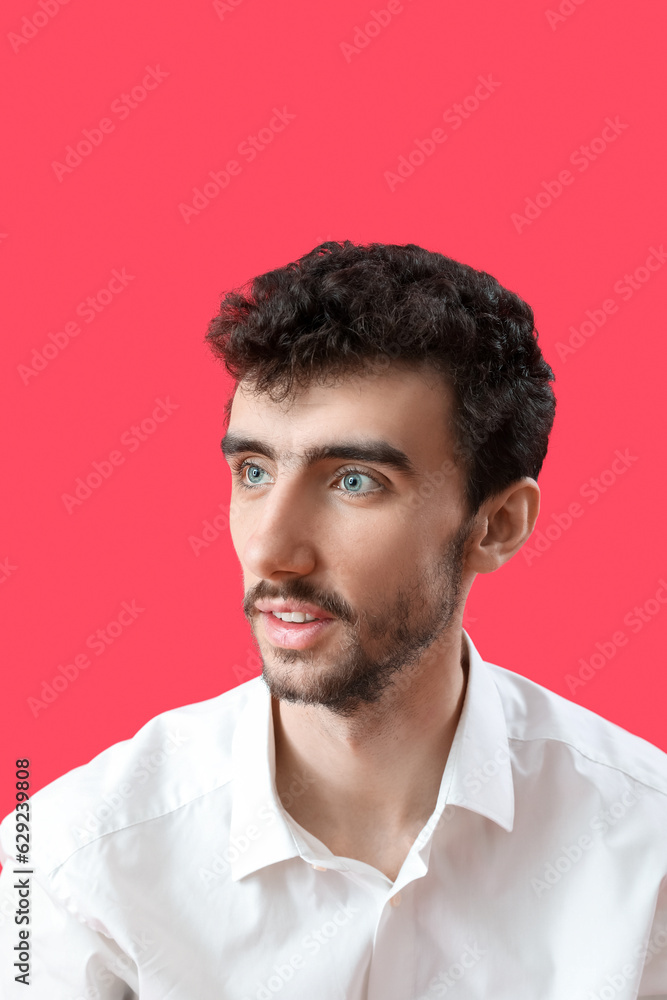 Fototapeta premium Young brunette man with stylish hairdo on red background, closeup