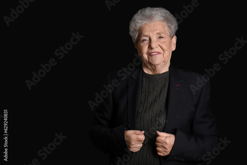 Senior woman on black background
