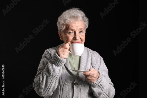 Senior woman with cup of co...