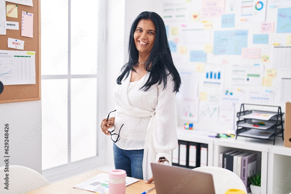 Middle age hispanic woman business worker smiling confident at office Middle age hispanic woman business worker smiling confident at office