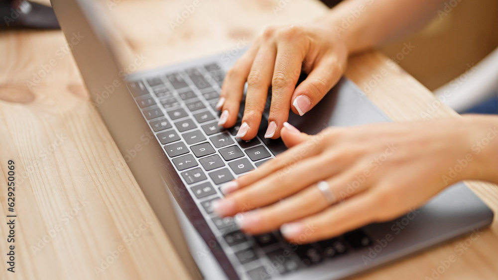 Young blonde woman using laptop sitting on table at office Young blonde woman using laptop sitting on table at office