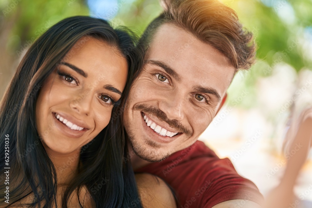 Man and woman couple making selfie by smartphone at park Man and woman couple making selfie by smartphone at park