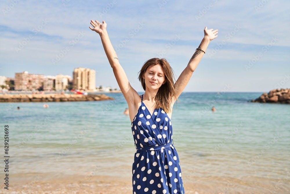 Young blonde woman tourist stretching arms breathing at beach Young blonde woman tourist stretching arms breathing at beach