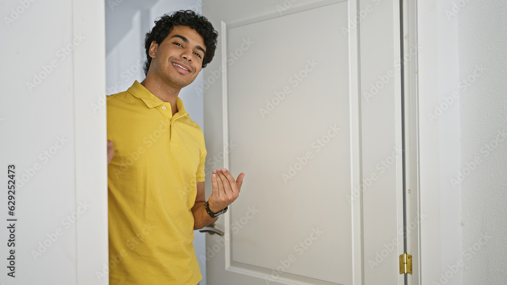 Young latin man smiling confident asking for coming at home Young latin man smiling confident asking for coming at home