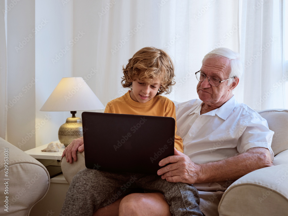 Boy with grandfather surfing laptop Boy with grandfather surfing laptop