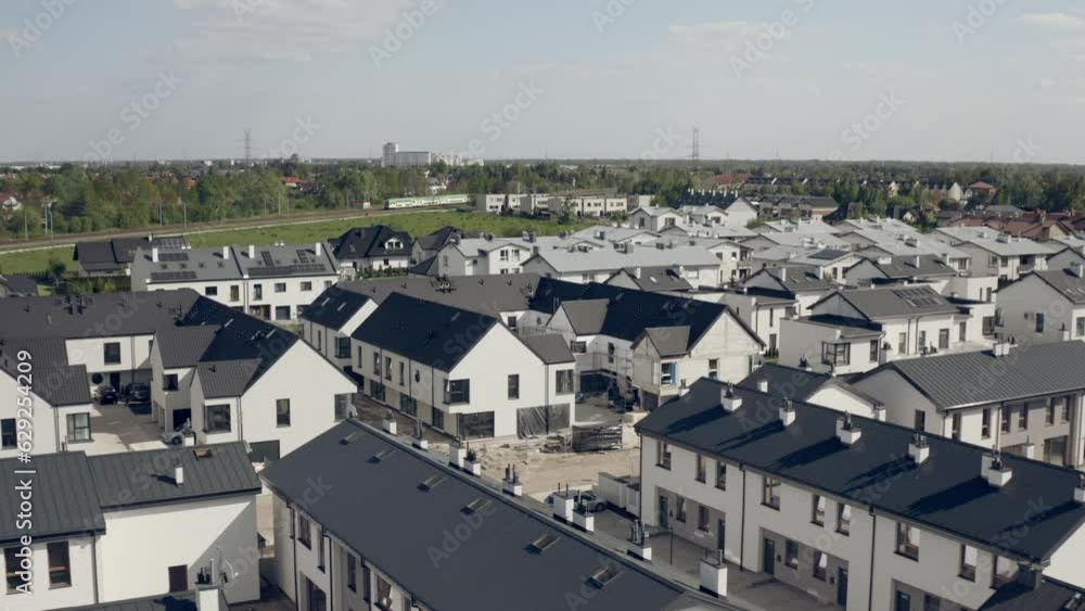 Aerial view of rows of traditional houses roofs with cultivated lawns with cloudy sky Aerial view of rows of traditional houses roofs with cultivated lawns with cloudy sky