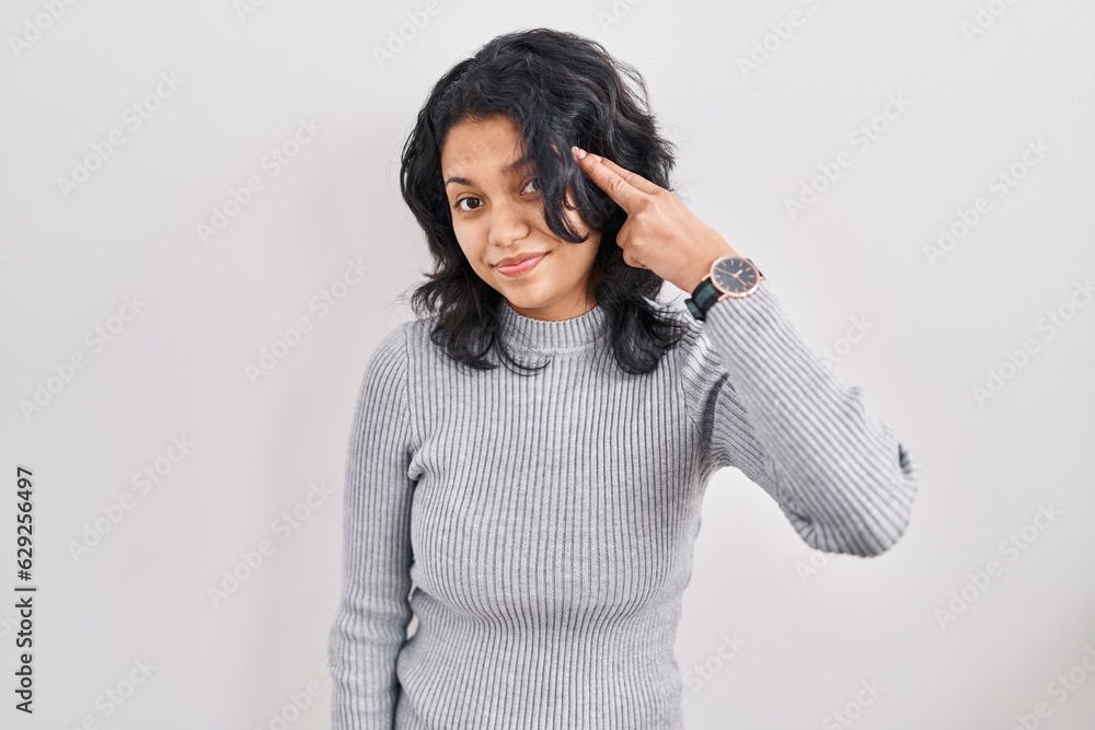 Hispanic woman with dark hair standing over isolated background shooting and killing oneself pointing hand and fingers to head like gun, suicide gesture. Hispanic woman with dark hair standing over isolated background shooting and killing oneself pointing hand and fingers to head like gun, suicide gesture.
