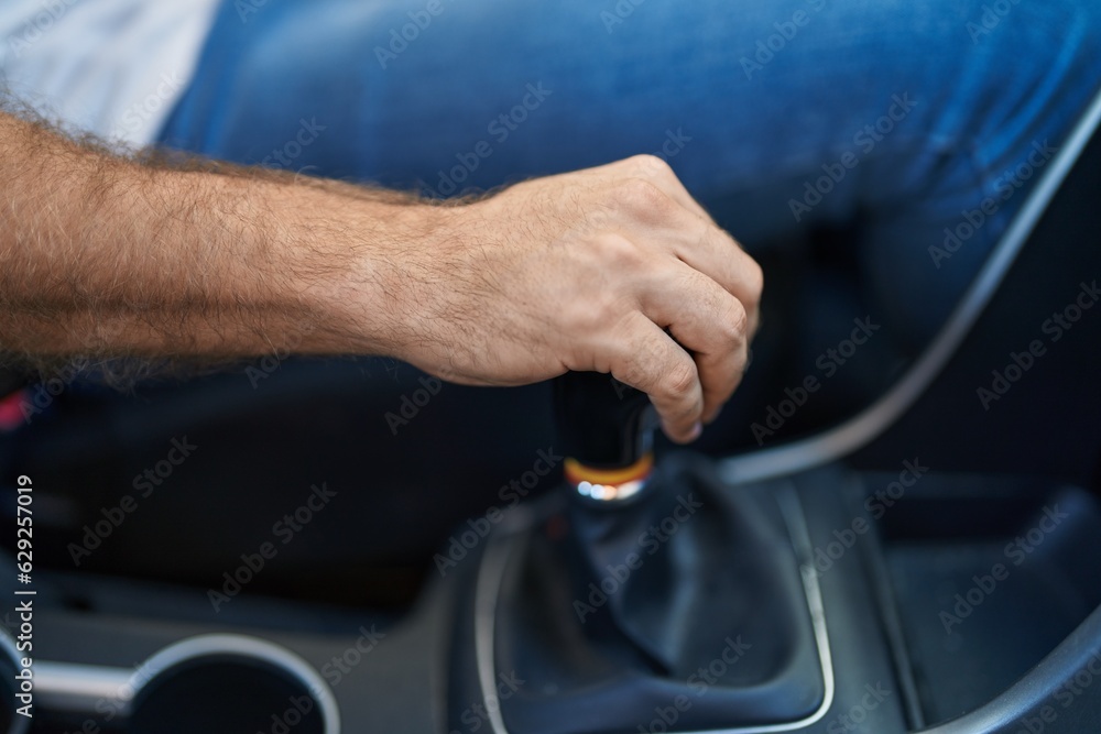 Young caucasian man touching gear shift car at street Young caucasian man touching gear shift car at street