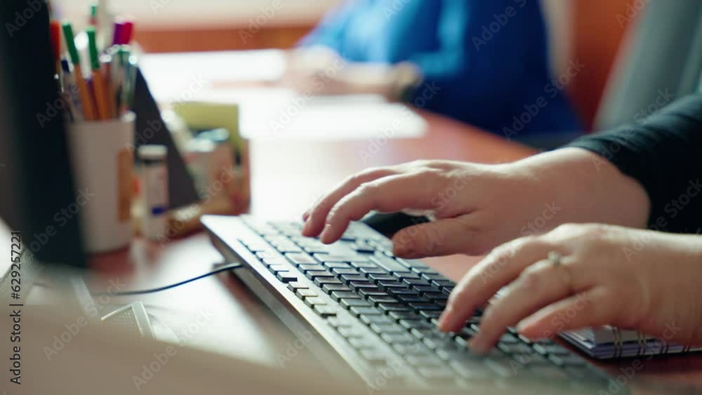 Closeup video of an old woman working on computer using mouse and keyboard Closeup video of an old woman working on computer using mouse and keyboard
