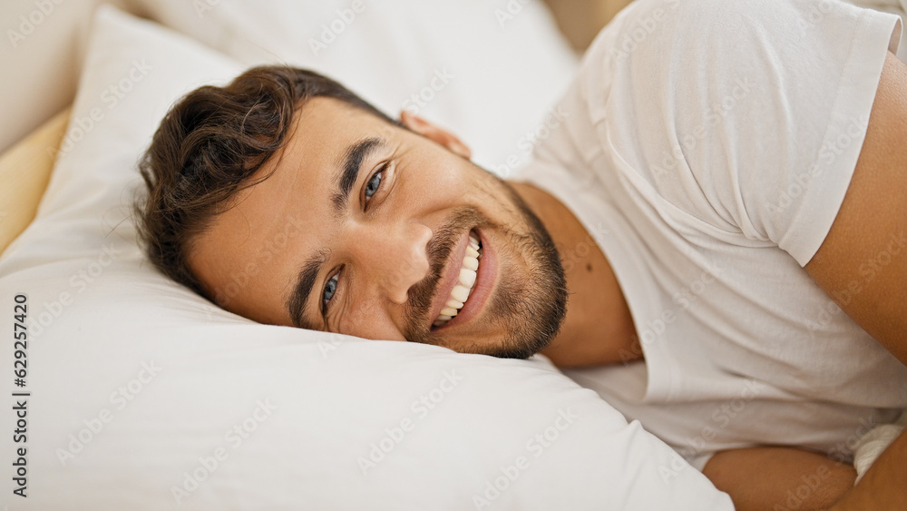 Young hispanic man smiling confident lying on bed at bedroom Young hispanic man smiling confident lying on bed at bedroom