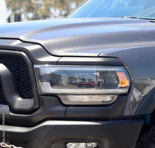 Under the brilliant embrace of the sun s warm and golden rays  a sleek black pickup truck stands as the epitome of automotive elegance. Its polished exterior exudes a timeless allure.