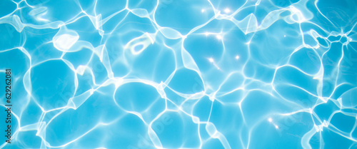 Clear blue water in the pool under the rays of the sun. Banner
