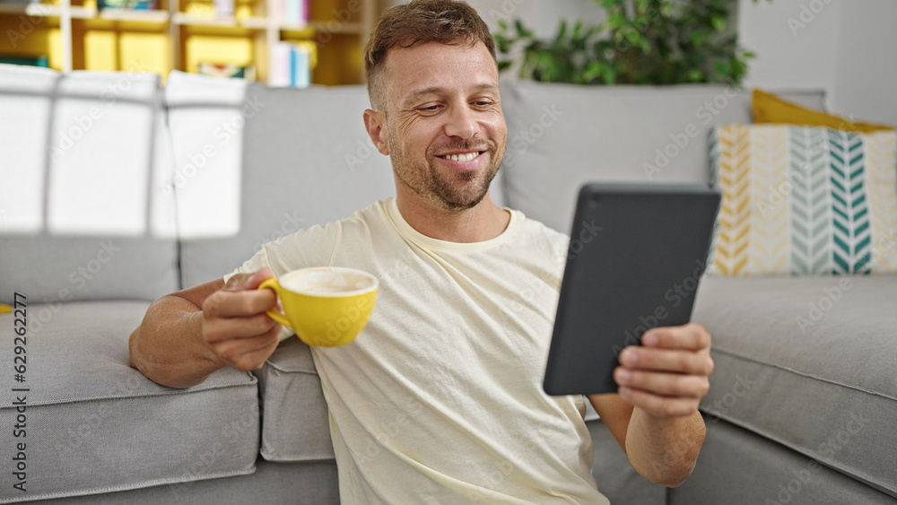 Young man having video call drinking coffee at home Young man having video call drinking coffee at home