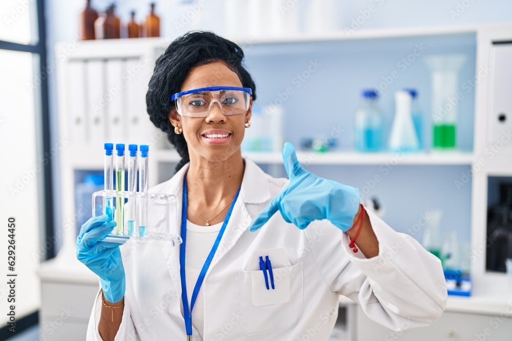 Middle age hispanic woman working at scientist laboratory pointing finger to one self smiling happy and proud Middle age hispanic woman working at scientist laboratory pointing finger to one self smiling happy and proud