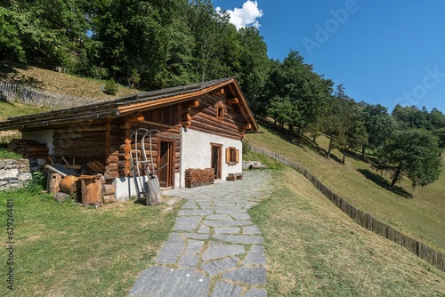 Obraz na płótnie Scenic view of a wooden hut on a green hill at Heidi's Village
