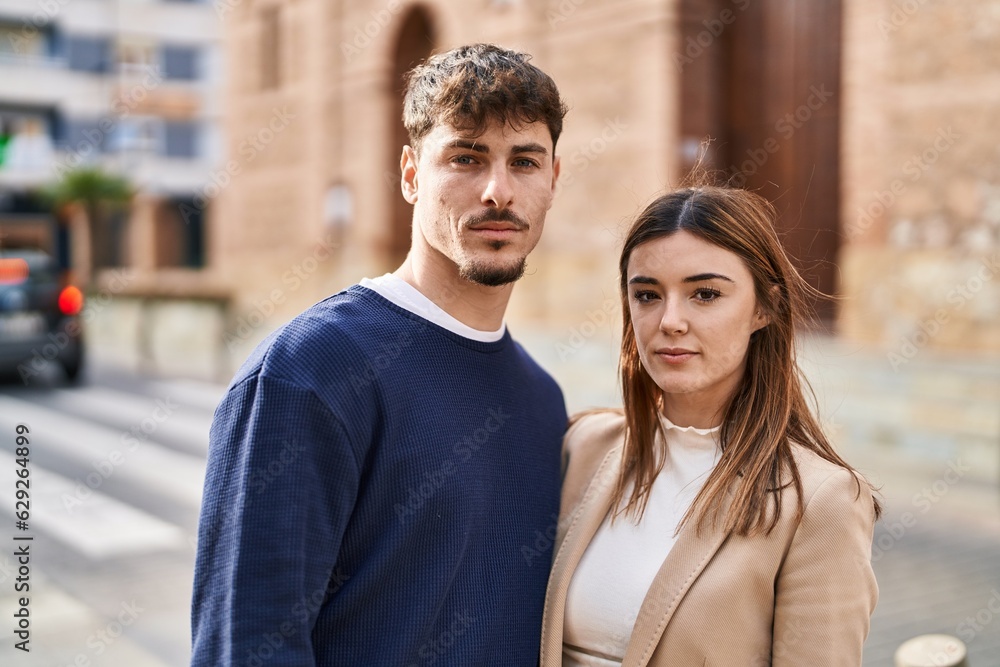 Mand and woman couple standing together with serious expression at street Mand and woman couple standing together with serious expression at street