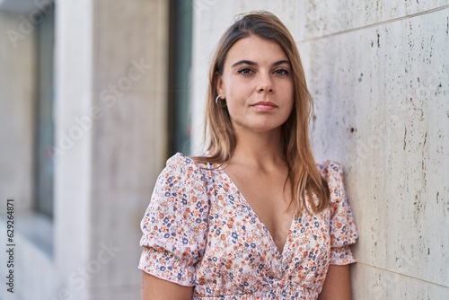 Young woman with relaxed expression standing at street