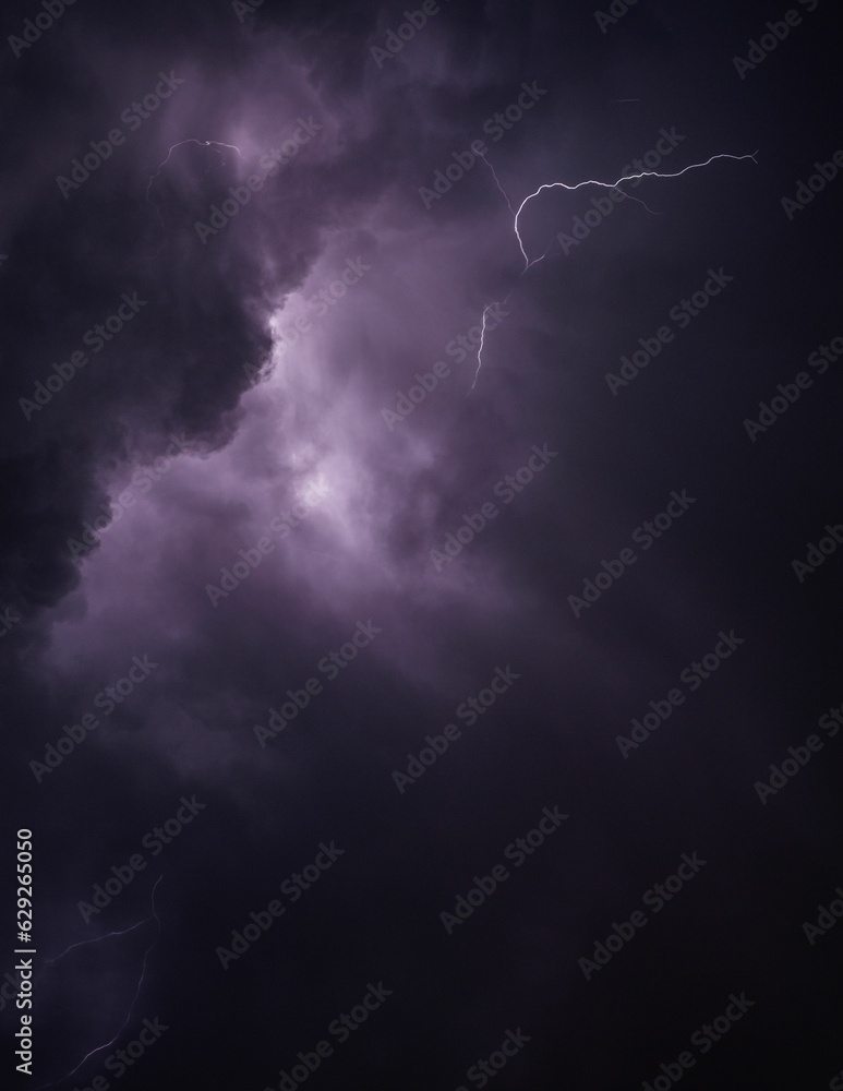 a lightning bolt breaking into the air above clouds in purple a lightning bolt breaking into the air above clouds in purple