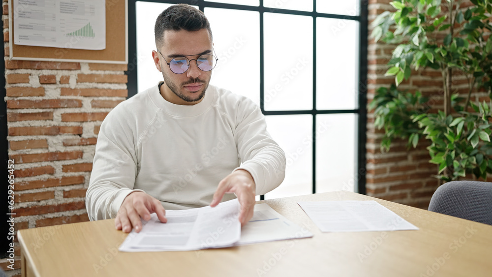 Young hispanic man business worker smiling confident holding documents at office Young hispanic man business worker smiling confident holding documents at office
