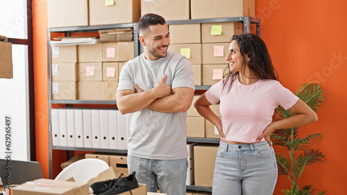 Man and woman ecommerce business workers standing together smiling at office
