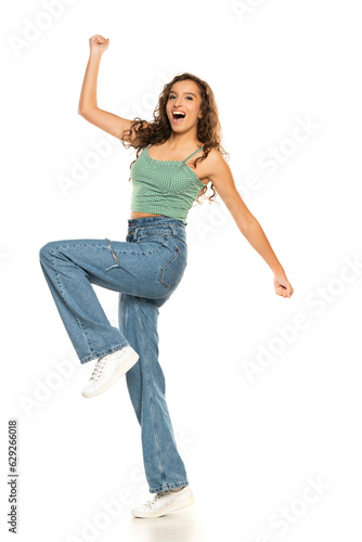 Happy young woman with success hand gesture on a white studio background