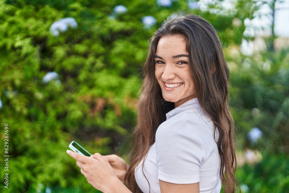 Young hispanic woman smiling confident using smartphone at park Young hispanic woman smiling confident using smartphone at park