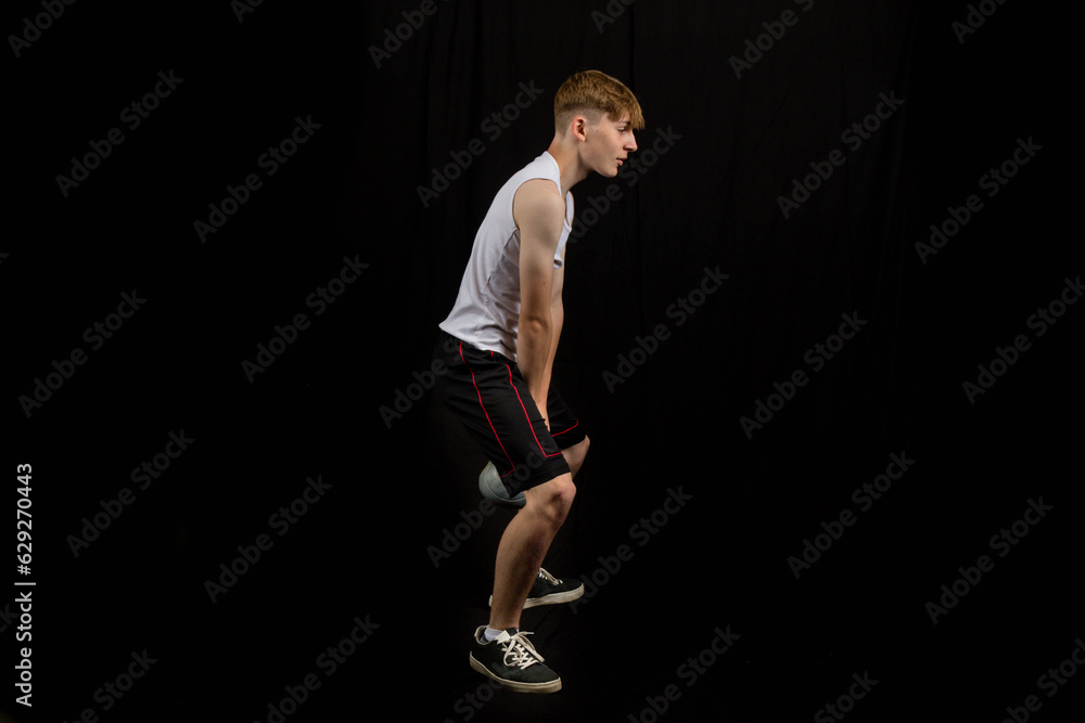 Teenage boy doing kettlebell swings Teenage boy doing kettlebell swings