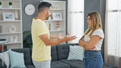Photos Man and woman couple standing together arguing at home