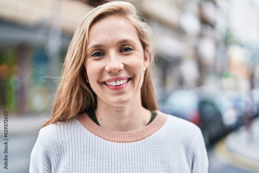 Young blonde woman smiling confident standing at street Young blonde woman smiling confident standing at street
