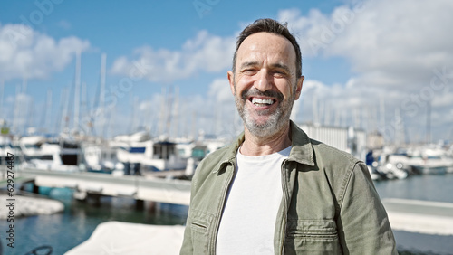 Middle age man smiling confident standing at port