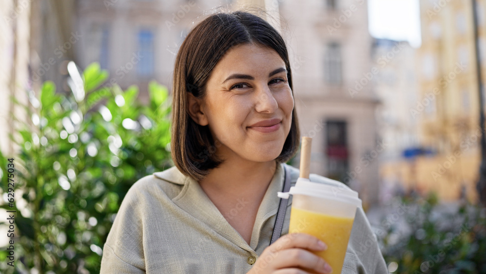 Young beautiful hispanic woman drinking bubble tea in the streets of Vienna Young beautiful hispanic woman drinking bubble tea in the streets of Vienna