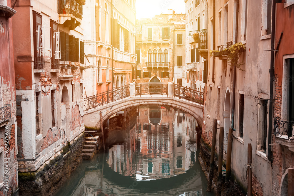 Narrow canal with a bridge in Venice, Italy