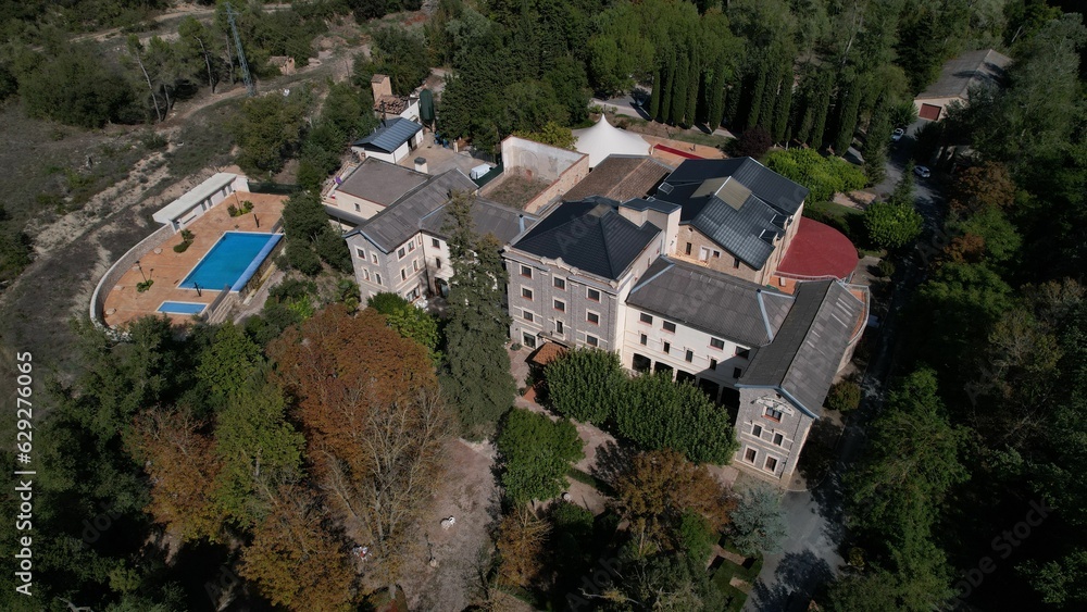 Aerial view of a large, three-story country house in Vallfogona, Spain