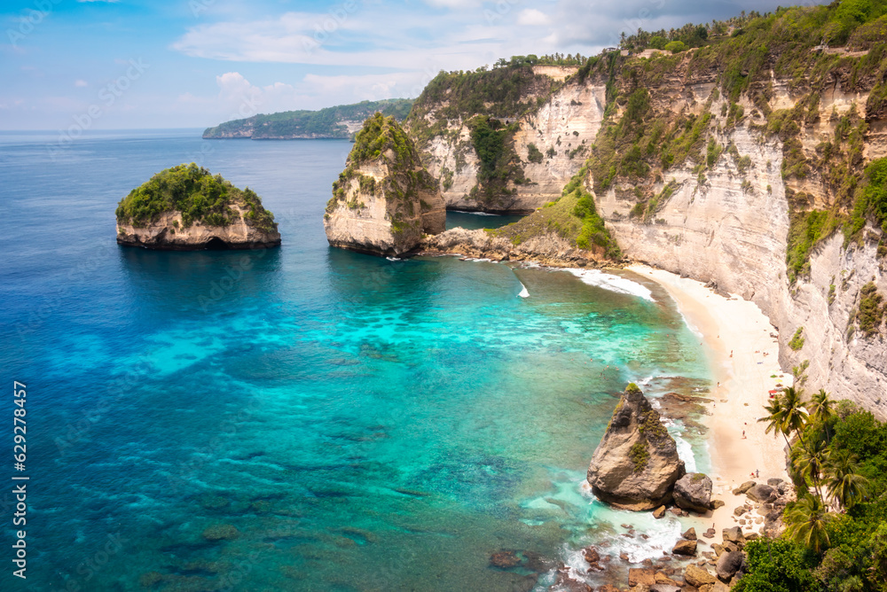 Tropical beach with white sand and palm trees, beach holiday destination on Bali island