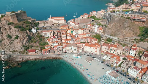 aerial view of the beautiful village of Scilla and Chianalea in Calabria. Note the houses overlooking the sea, the Ruffo castle, the seaside restaurants and the crystal clear Caribbean sea photo