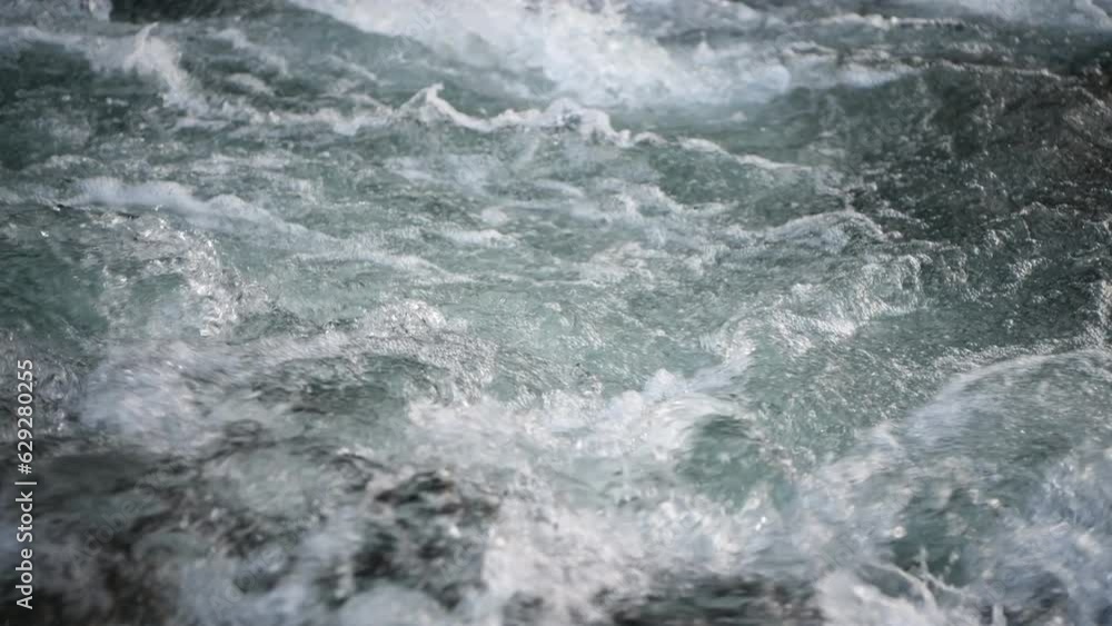 A beautiful view of flowing river water in the mountains. A stream of clear water. Close up. A beautiful view of flowing river water in the mountains. A stream of clear water. Close up.