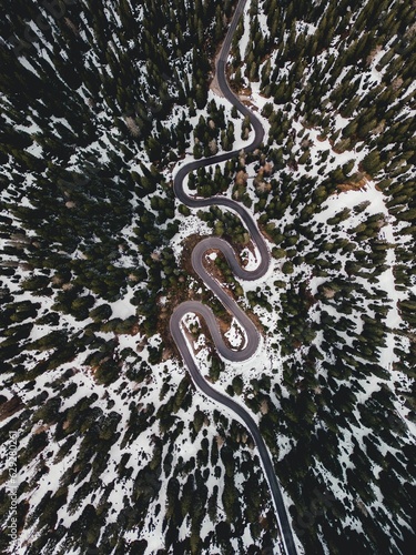 Aerial view of the winding Snake Road in winter in the Dolomite Alps of Italy. © Thelonetuga/Wirestock Creators