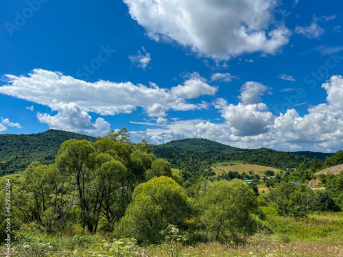 Awesome Carpathian mountains landscape background with forest and clouds on the summer season 