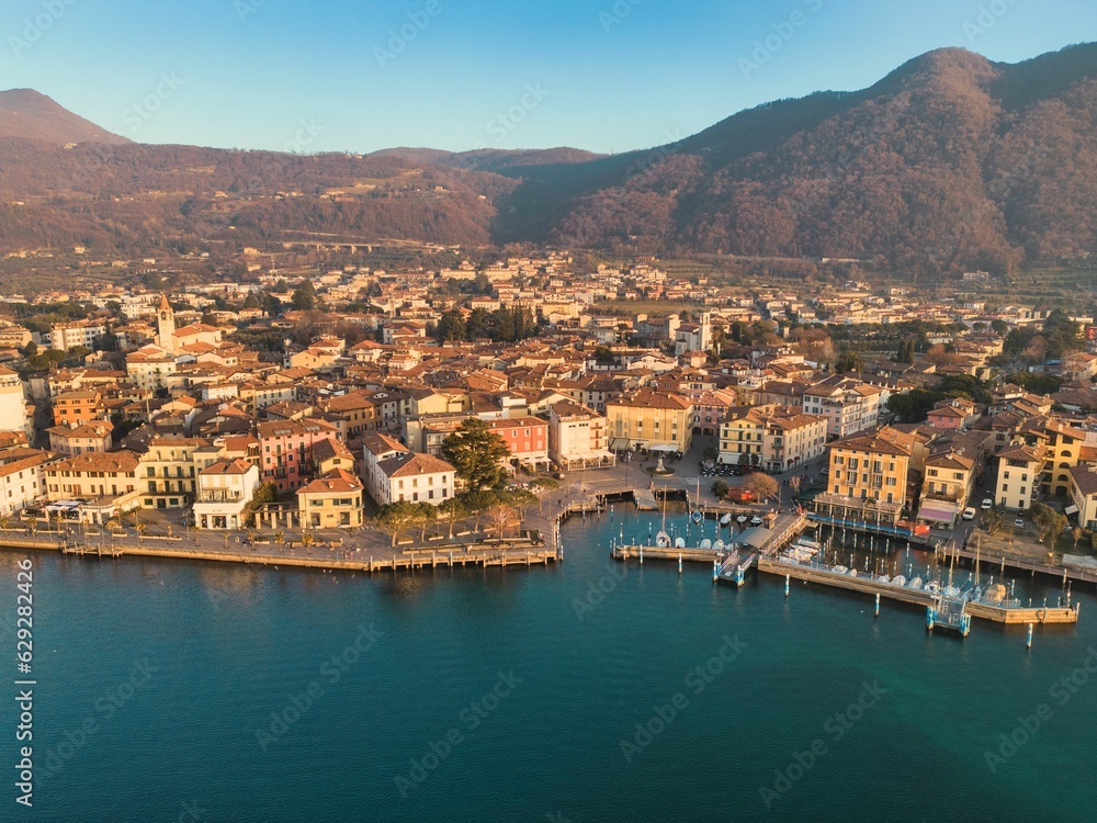 Aerial view of the beautiful Iseo harbor with the city in the background in Italy