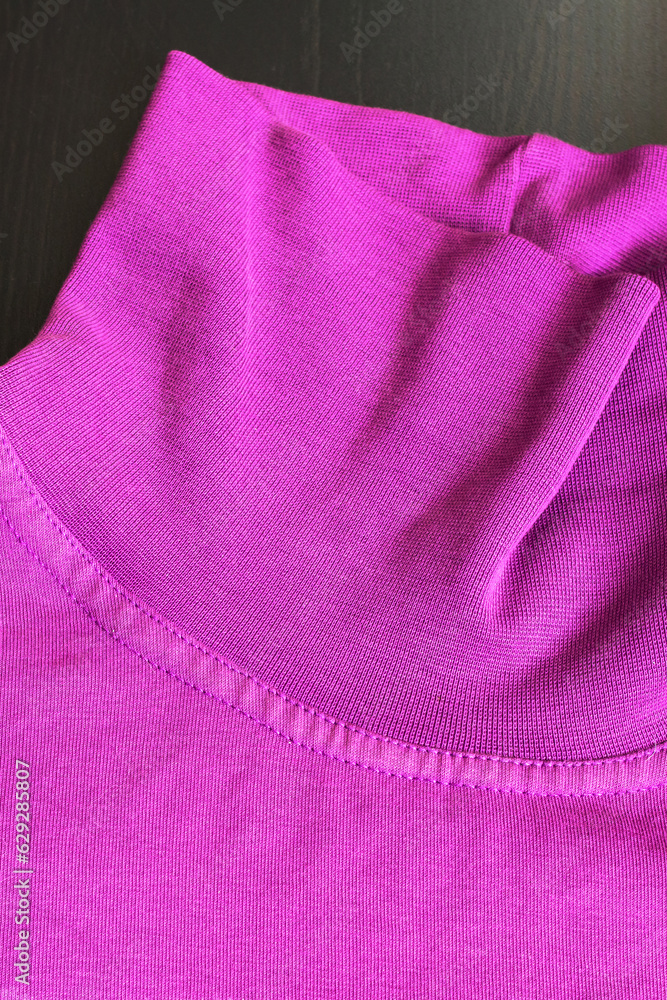 Part of pink sweater on wooden background Part of pink sweater on wooden background